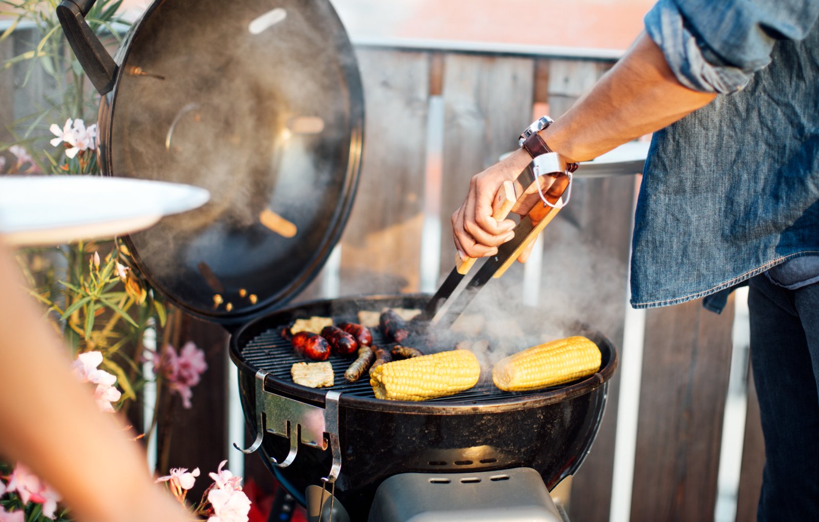 Man broiling Golden Phoenix corn on the cob.