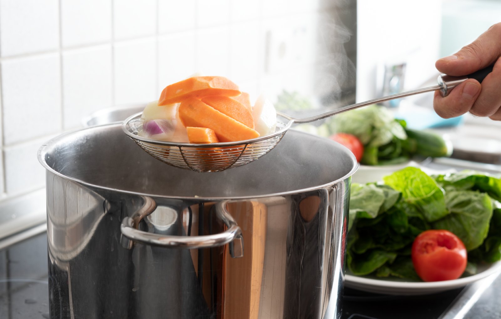 Man steaming Golden Phoenix vegetables.