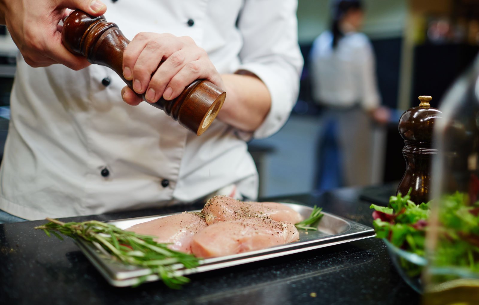 Chef seasoning Golden Phoenix chicken.